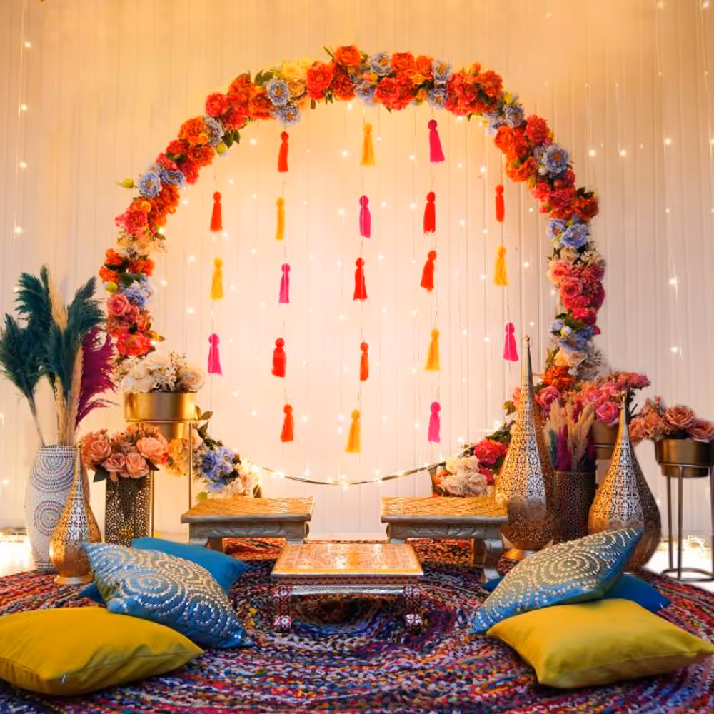 The brass lamps and pots filled with flowers make the Haldi event provide a traditional outlook