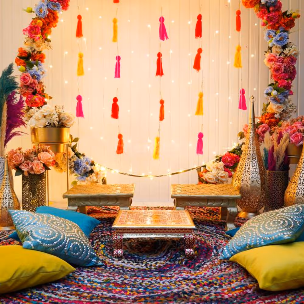 The stunning ring backdrop with lights and flower bunches is perfect for pictures of the Mehndi ceremony