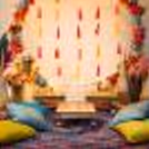The stunning ring backdrop with lights and flower bunches is perfect for pictures of the Mehndi ceremony