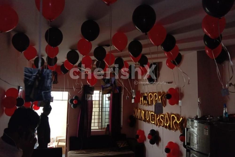 Red and Black Balloon Theme used for Anniversary Special Balloon Room Decoration.