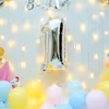 The frill curtain and colourful balloons make an attractive backdrop
