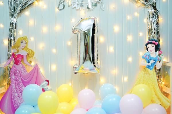 The frill curtain and colourful balloons make an attractive backdrop