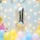 The frill curtain and colourful balloons make an attractive backdrop