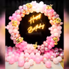 Get a 'Happy Birthday' Neon Light Sign with Pink Balloon Arch.