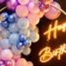 The multi-colored balloon arch is the perfect room and rooftop birthday decoration idea.