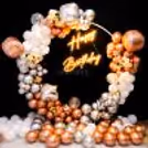 This dreamy metallic ring backdrop is adorned with silver and rose gold balloos