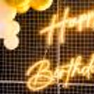A magical experience with multiple balloons, neon lights, and flowers.