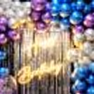 The multiple stunning chrome balloons and neon light sets look extravagant.