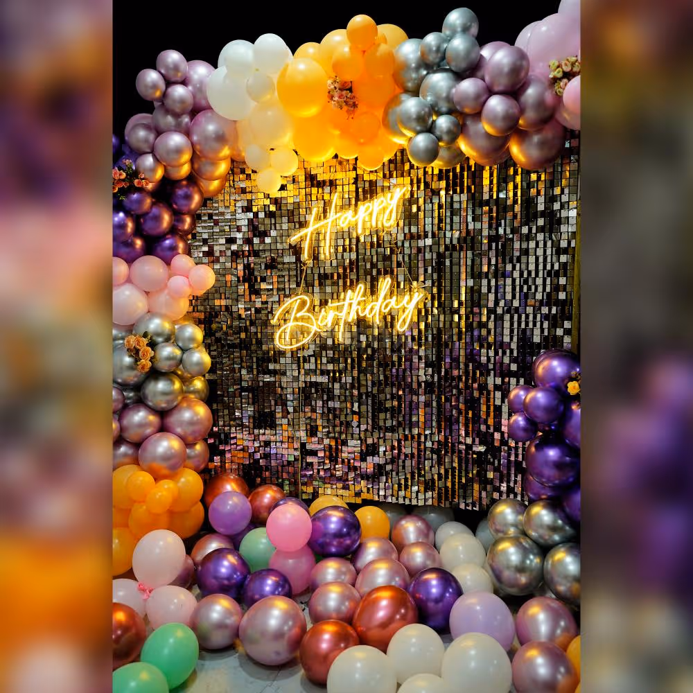 Make a statement with this vibrant and lively balloon and silver shimmery backdrop.