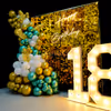 Balloons in shades of gold, silver and peach make for a stunning backdrop for a special 18th birthday celebration.