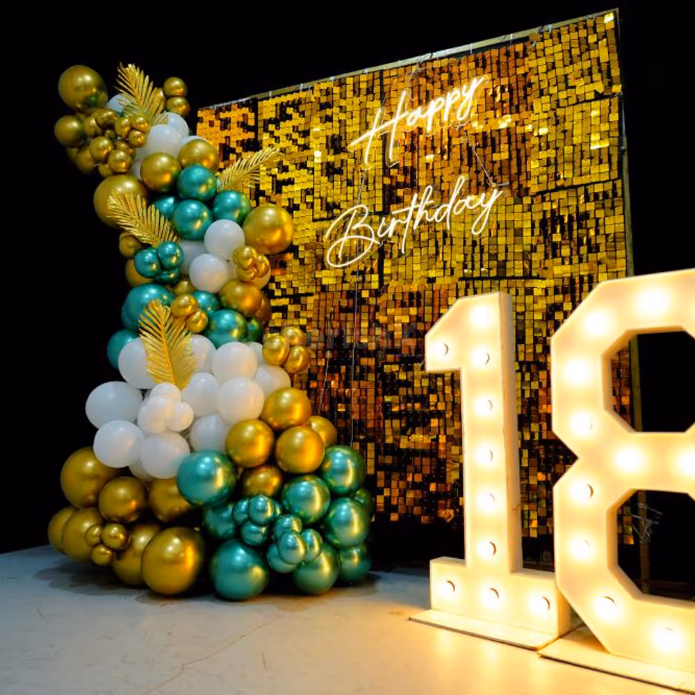 Balloons in shades of gold, silver and peach make for a stunning backdrop for a special 18th birthday celebration.
