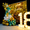 Balloons in shades of gold, silver and peach make for a stunning backdrop for a special 18th birthday celebration.