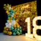 Balloons in shades of gold, silver and peach make for a stunning backdrop for a special 18th birthday celebration.
