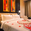 Rose petals on the bed will add a romantic flair between the two.