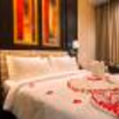 Rose petals on the bed will add a romantic flair between the two.