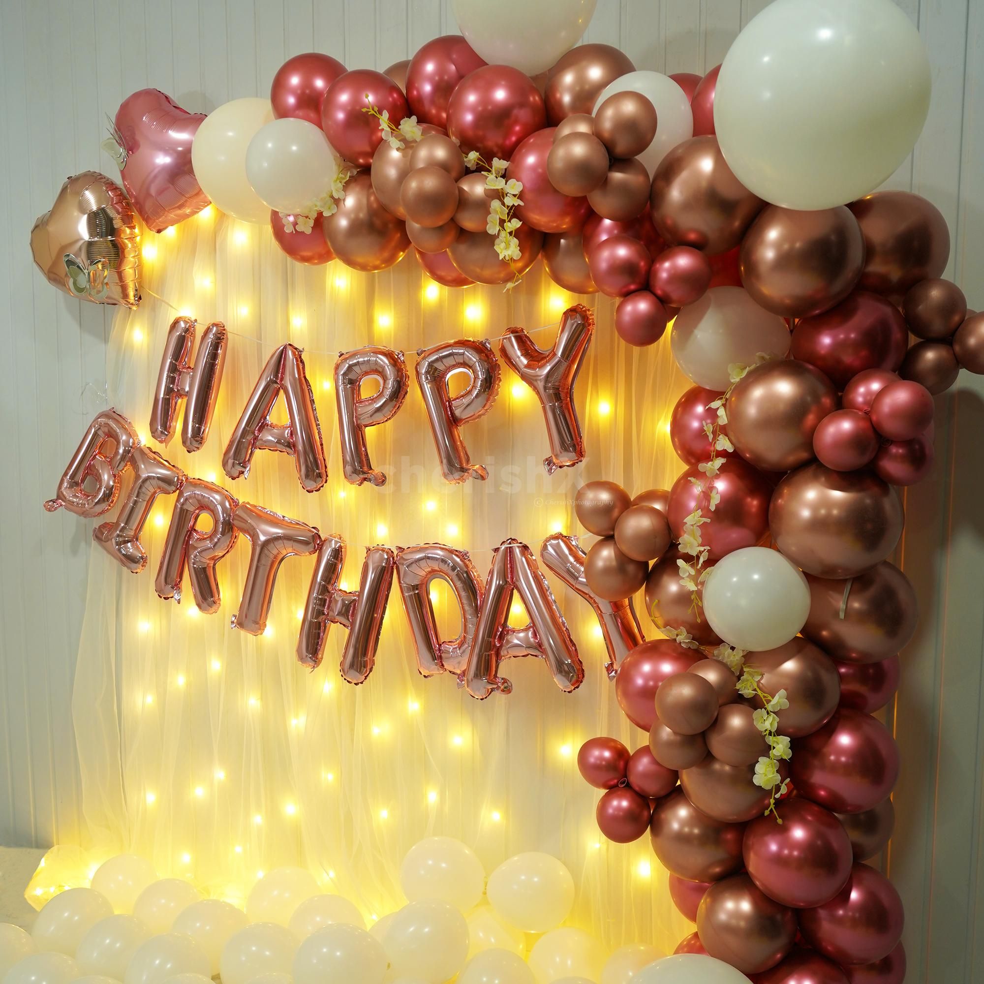 Happy Birthday foil balloons float gracefully in the air, their vibrant colours adding a cheerful touch to the celebration.