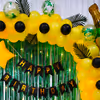 The vibrant yellow balloons and elegant green curtains transform your party ambience.