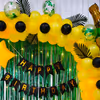 The vibrant yellow balloons and elegant green curtains transform your party ambience.