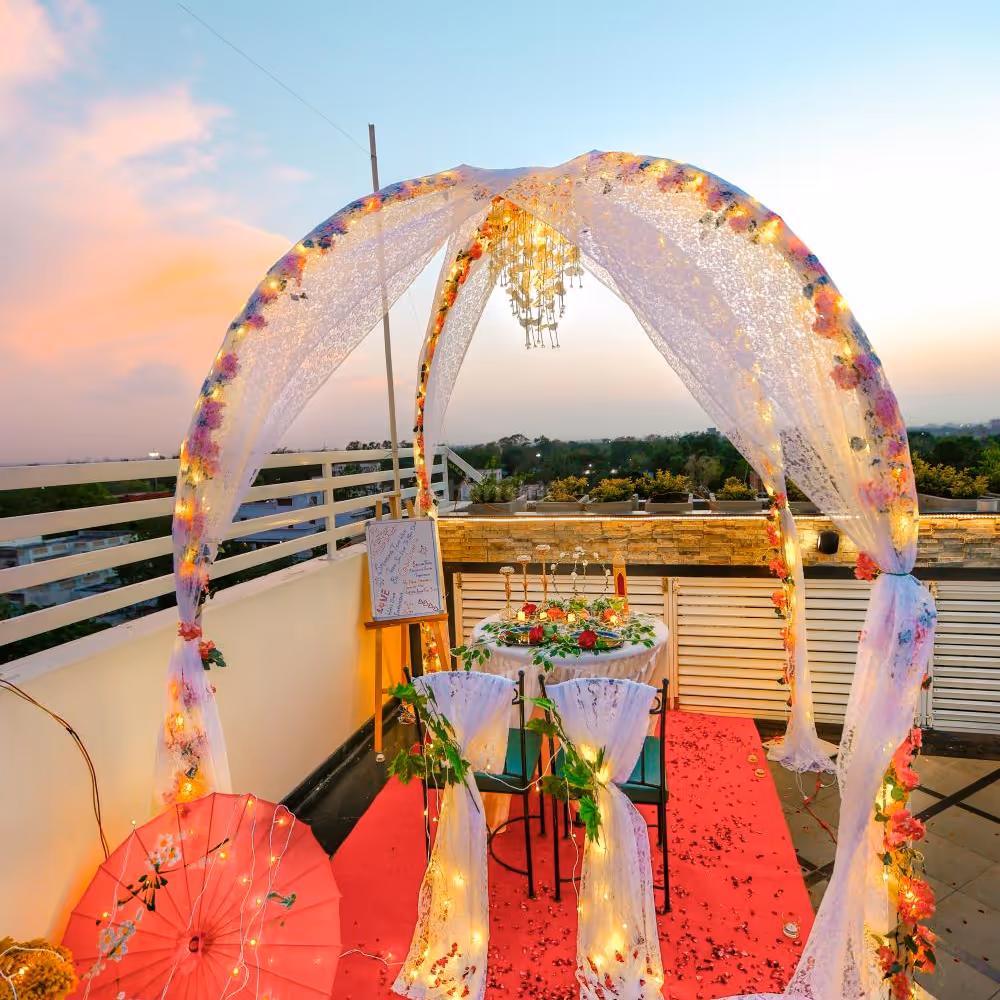 The table is beautifully adorned with a sea of delicate flower petals, creating a stunning visual spectacle.