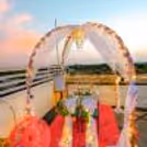 The table is beautifully adorned with a sea of delicate flower petals, creating a stunning visual spectacle.