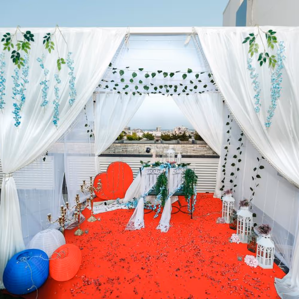 The table is beautifully adorned with a sea of delicate flower petals, creating a stunning visual spectacle.