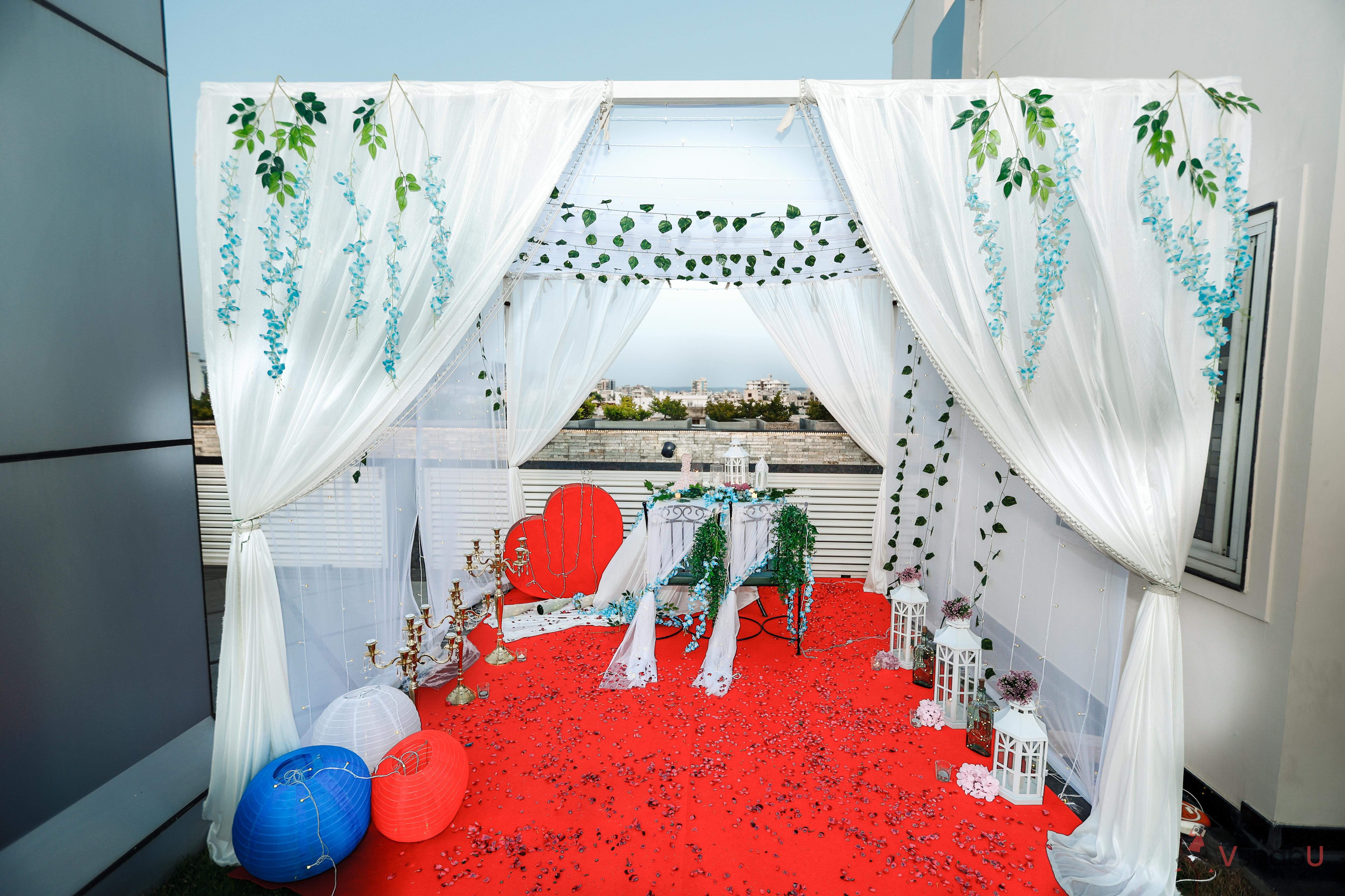 The table is beautifully adorned with a sea of delicate flower petals, creating a stunning visual spectacle.