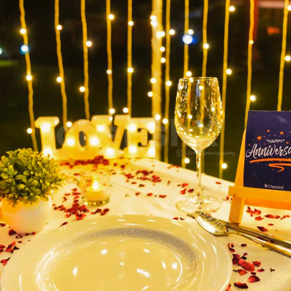 The flower petals and tea candles adorn the table, setting the stage for a truly magical evening.