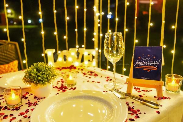 The flower petals and tea candles adorn the table, setting the stage for a truly magical evening.