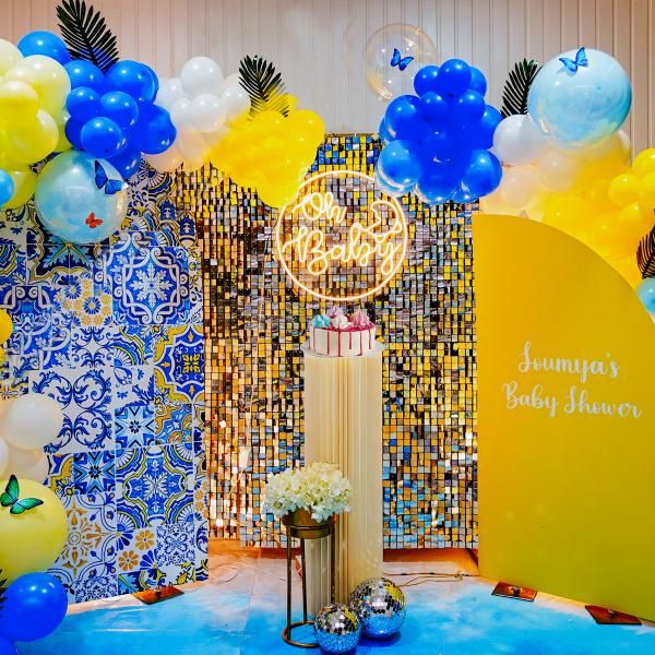 Experience the blissful ambience of our dreamy baby shower celebration, surrounded by the soothing hues of blue, yellow, and white balloons.