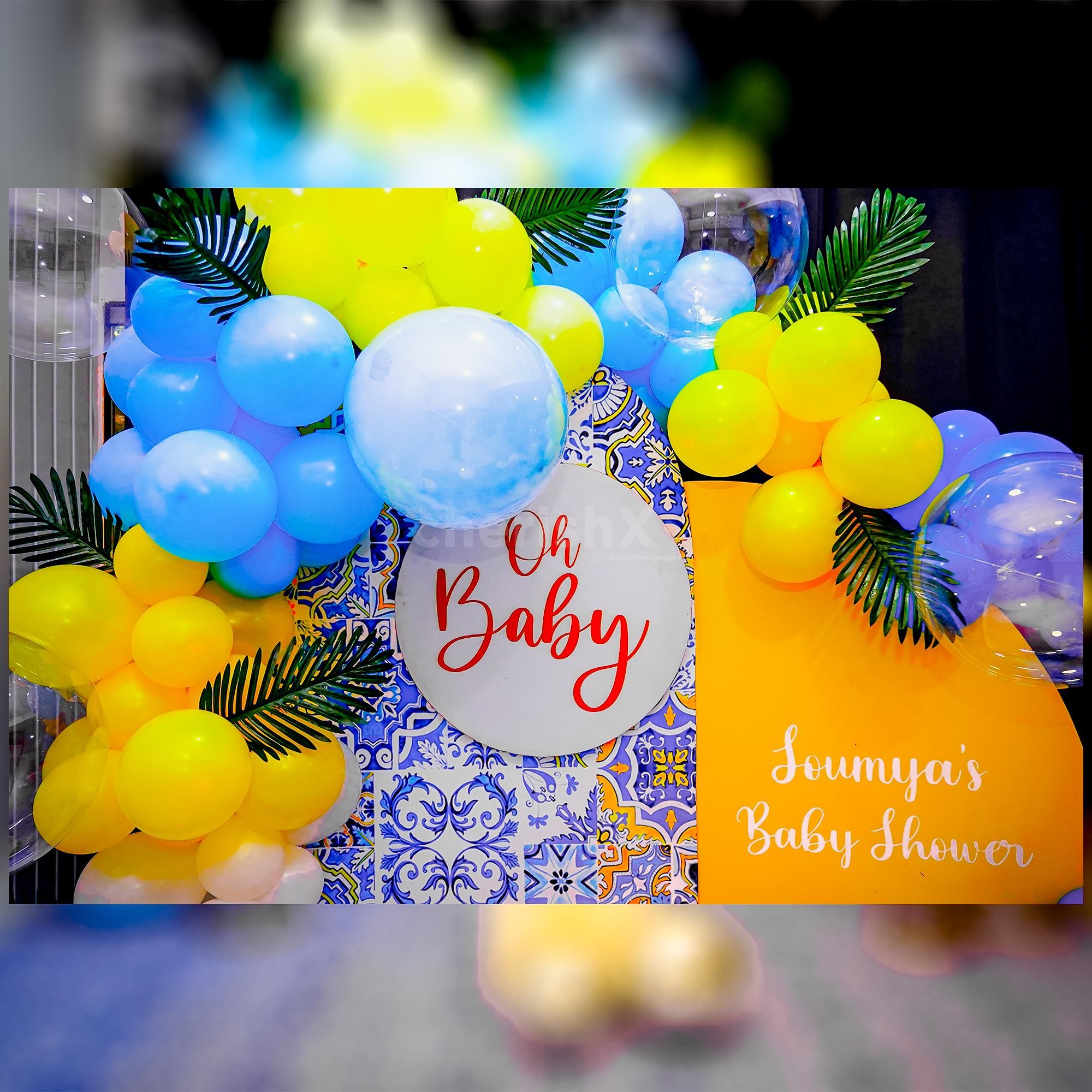 Delight in the harmonious blend of sun board cutouts and an array of bubble balloons and artificial palm leaves.
