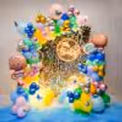 The burst of colourful balloons against the backdrop creates an enchanting and playful ambience that is sure to bring smiles to everyone's faces.
