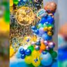 Indulge in the beauty of a rainbow-inspired backdrop, adorned with a burst of balloons in various shades.
