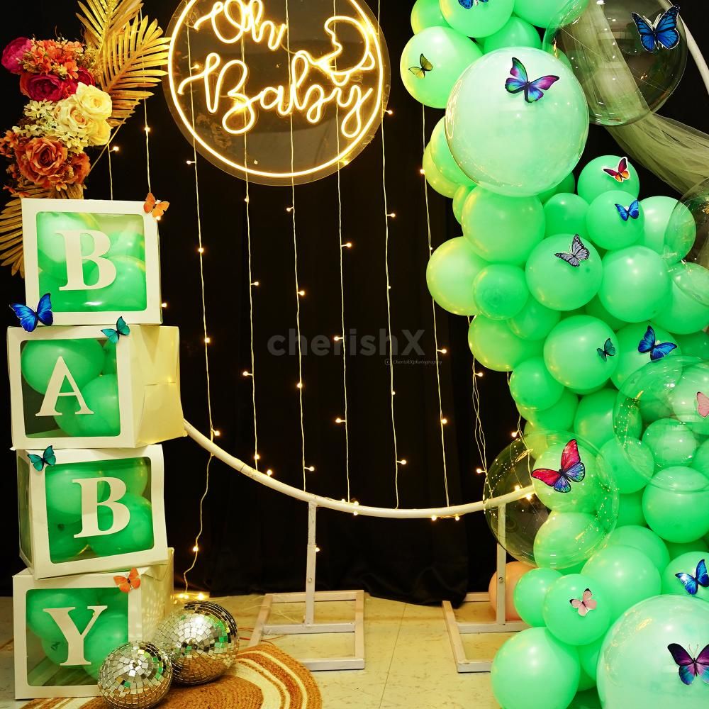 The delicate pastel green balloons, adorned with transparent bubble balloons, create a whimsical and ethereal ambience.