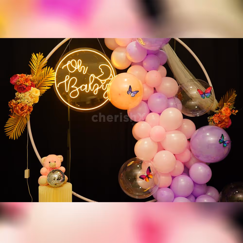 Golden Leaves and balloons embrace Nature's Beauty in Pastel baby shower decorations.