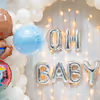 The white balloon backdrop with pastel foil balloons gives a breath of calmness.