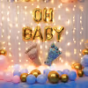 Gold confetti with pastel-coloured balloons makes a wonderful baby shower backdrop.