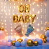 Gold confetti with pastel-coloured balloons makes a wonderful baby shower backdrop.