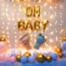 Gold confetti with pastel-coloured balloons makes a wonderful baby shower backdrop.