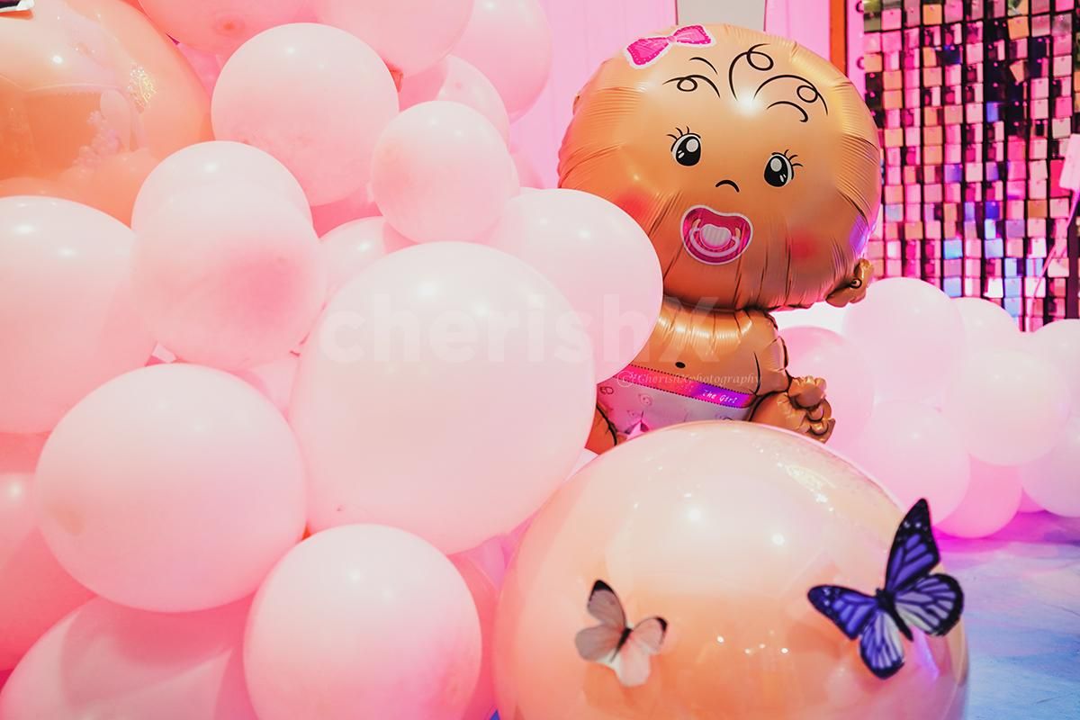 Experience the blissful ambience created by a harmonious mix of pink and blue bubble balloons, symbolizing the arrival of your precious little one.