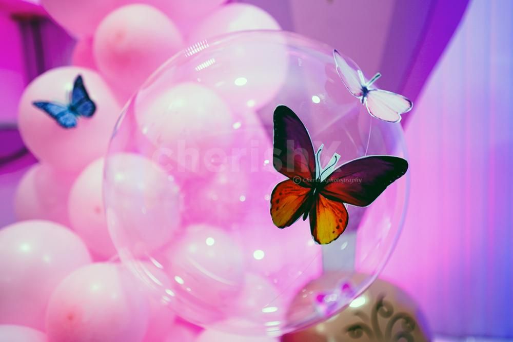 An arch of pink and blue balloons together make the evening picture perfect