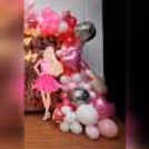 Barbie and car cutouts against a shimmering backdrop add more glam to the decor.