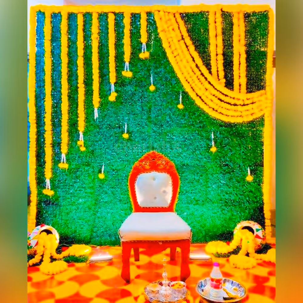 A backdrop adorned with vibrant green mats creates a fresh and natural atmosphere for the baby shower celebration.
