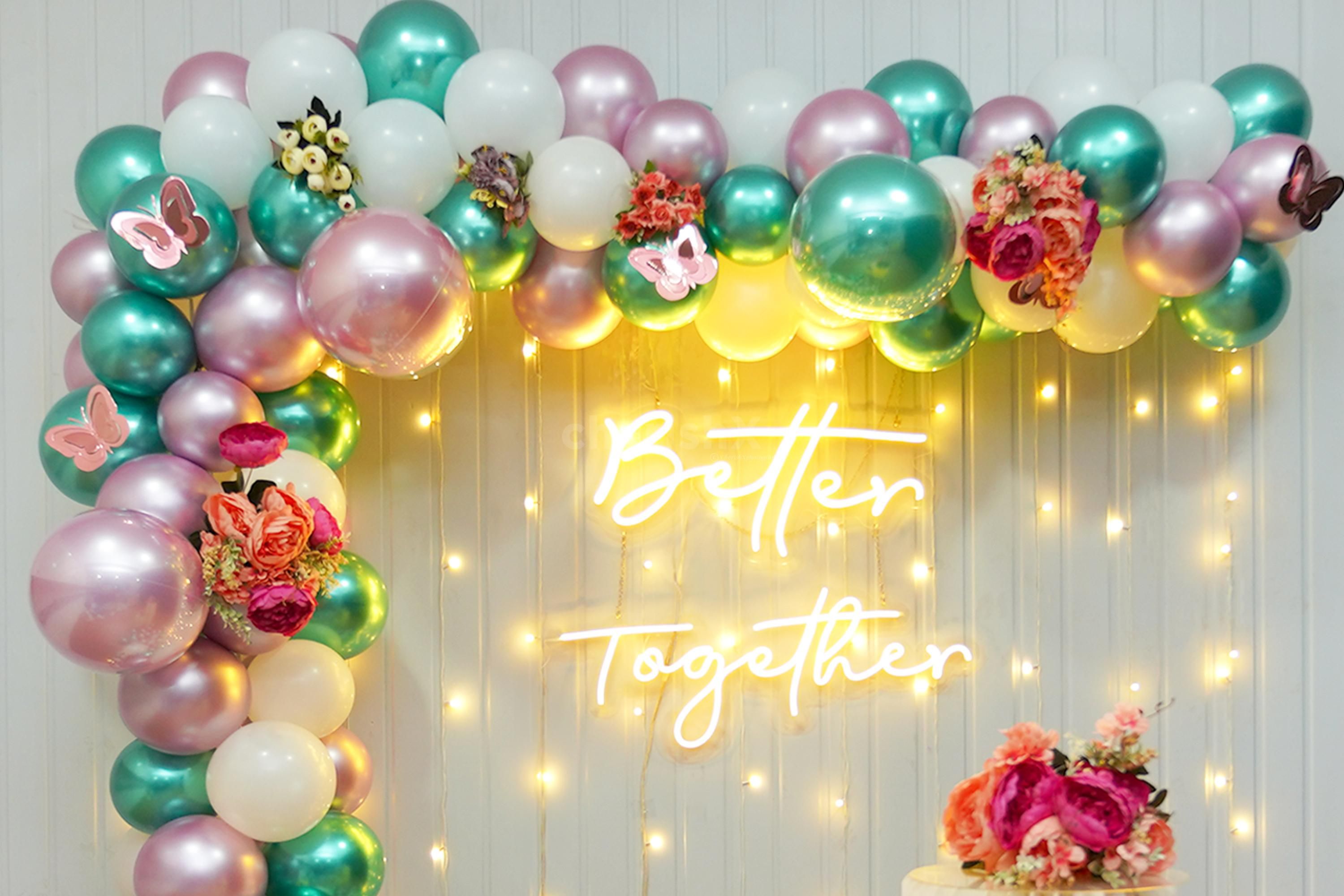 The blend of balloons with different colours such as pink, white, and green gives more of an enchanting look.