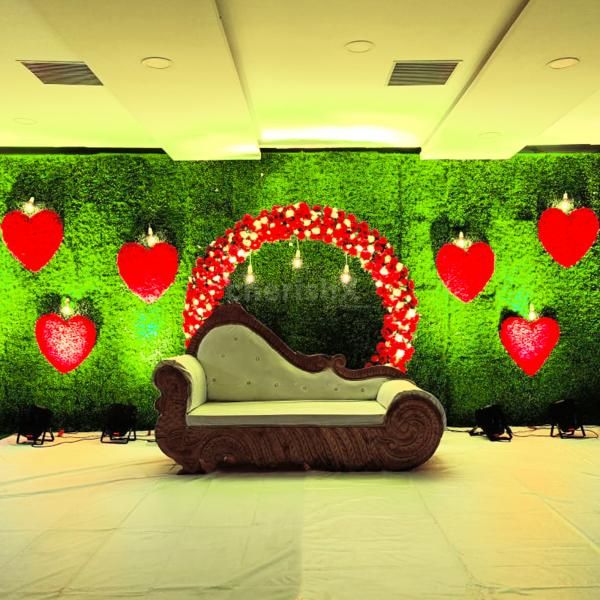Immerse yourself in an enchanting ambience with our stunning artificial grass backdrop adorned with natural Gerbera flowers and leaves.