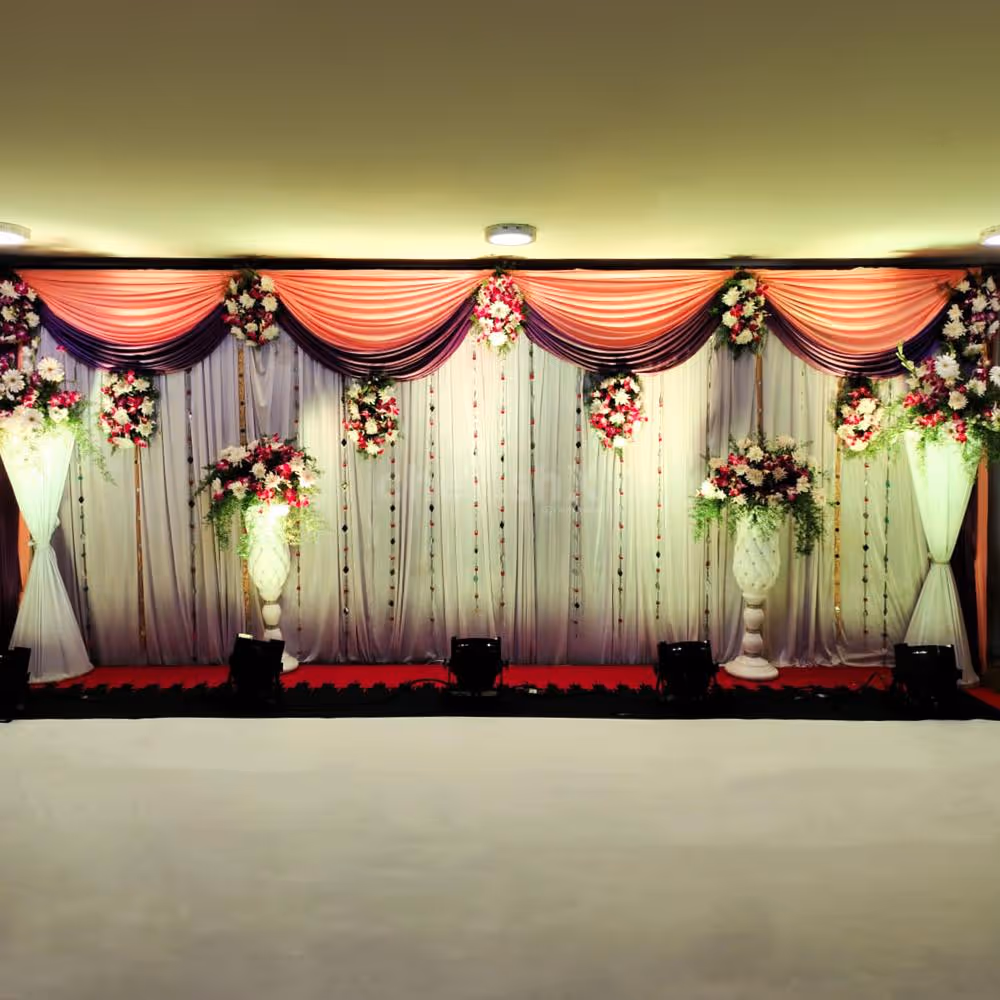 Embrace the charm of nature with fresh krishantham, arcades, and white daisy flowers, gracefully arranged on the stage backdrop.