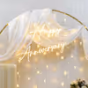 Experience the magic of our heartwarming ring floral backdrop adorned in warm-glowy pixel lights.