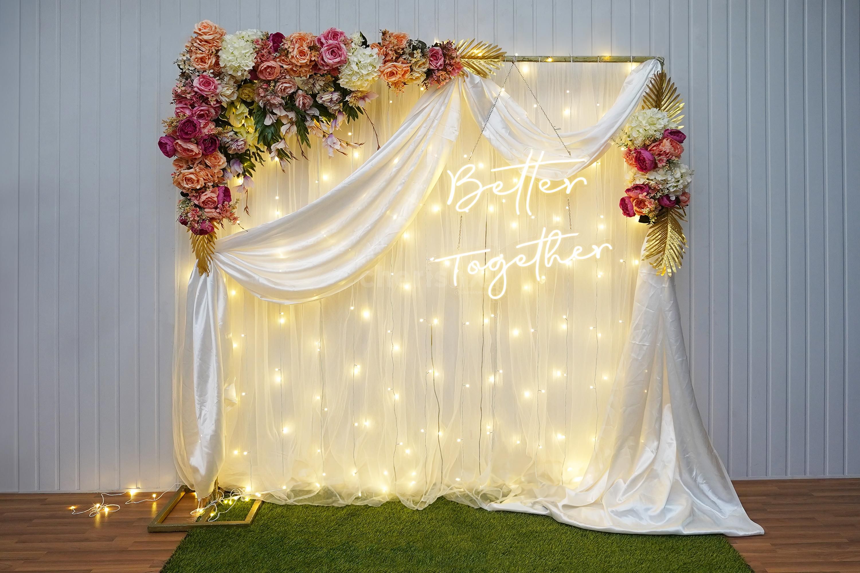 A Tale of Elegance: Drape, Stand, Lights Unveil Harmonious Anniversary Decor.