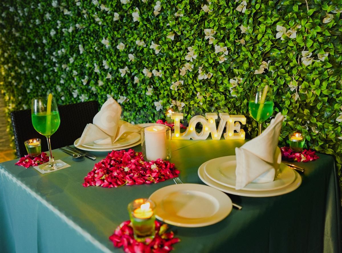 Delight in the Intimate Ambience, adorned with Flower Petals and Flickering Candles.
