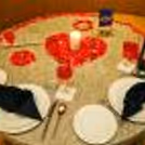 Enter a space adorned with artistic candles and flower petals.