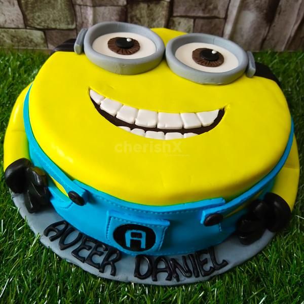 A Minion Delight! Our adorable fondant cake brings the mischievous charm of Minions to your child's birthday!